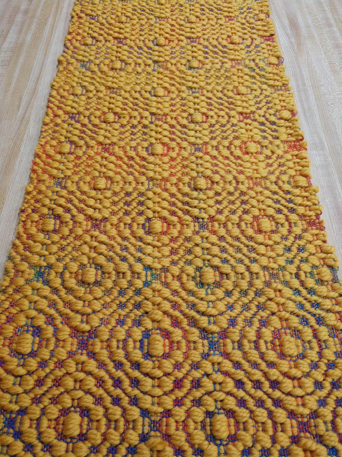 overshot weave in yellow on rainbow background
