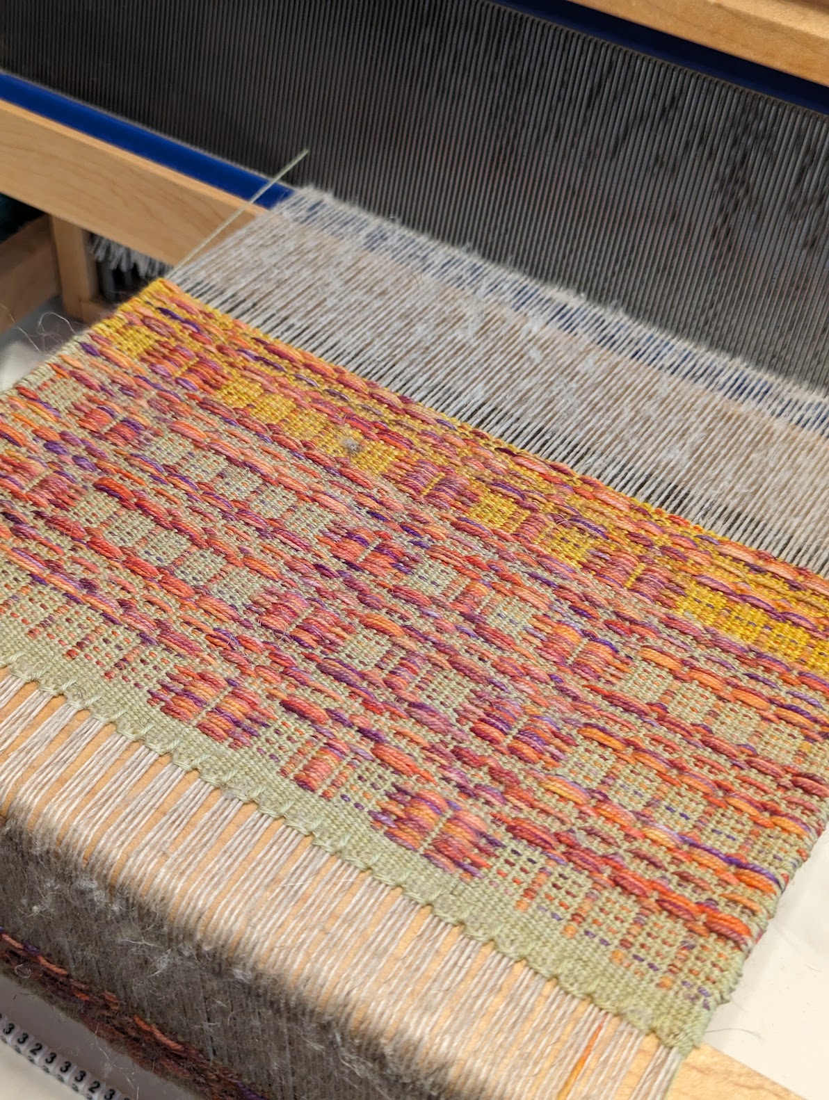 woven earth-colored fabric on the loom